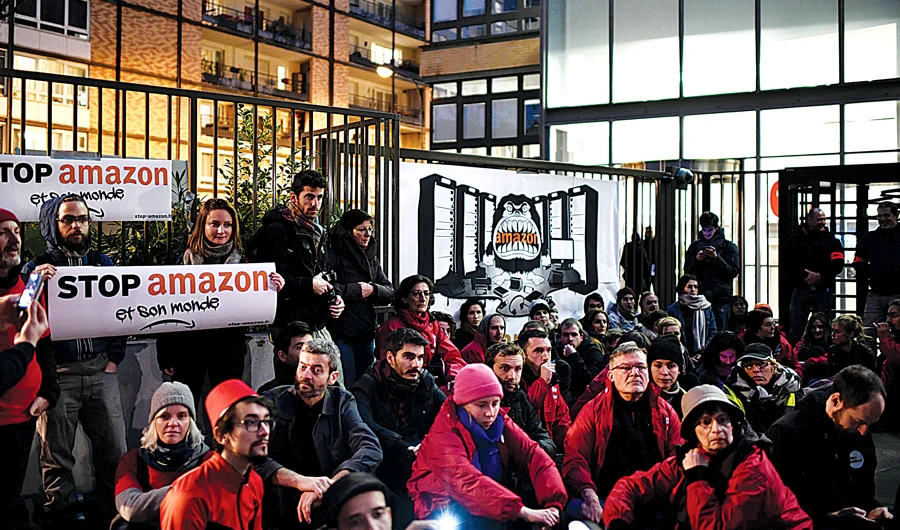Activists in front of Amazon’s French headquarters, near Paris. (AFP)