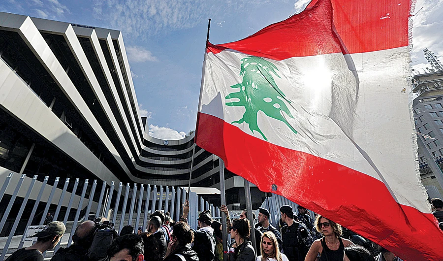 Lebanese protesters gather outside a Ministry of Finance department. Growth in Lebanon has been battered by years of stubborn political deadlock. (AFP)