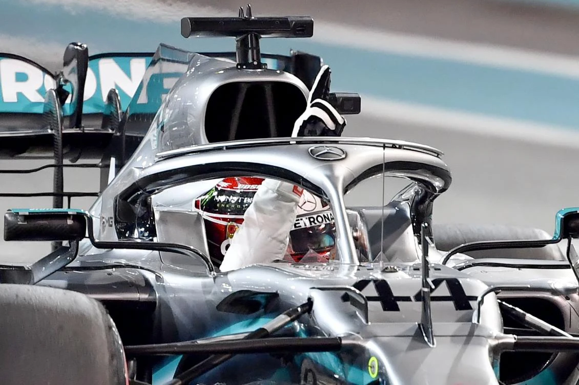 Mercedes' British driver Lewis Hamilton celebrates taking the pole position after the qualifying session at the Yas Marina Circuit in Abu Dhabi, a day ahead of the final race of the season, on November 30, 2019. (AFP)