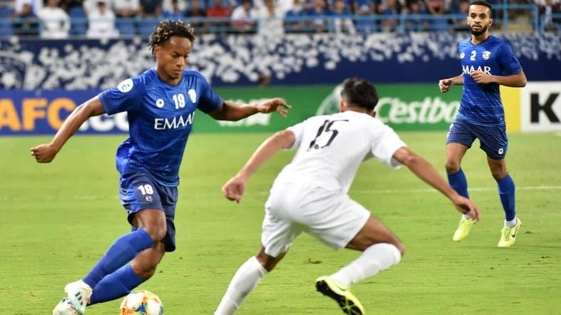 Al Hilal’s Andre Carrillo is faced by Al Sadd’s Tarek Salman in the semifinal of the Asian Champions League. (AFP)