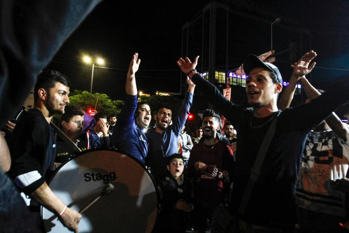 Protesters chant slogans and strike a drum during an anti-government demonstration in the southern Lebanese city of Sidon on December 1, 2019. (AFP)