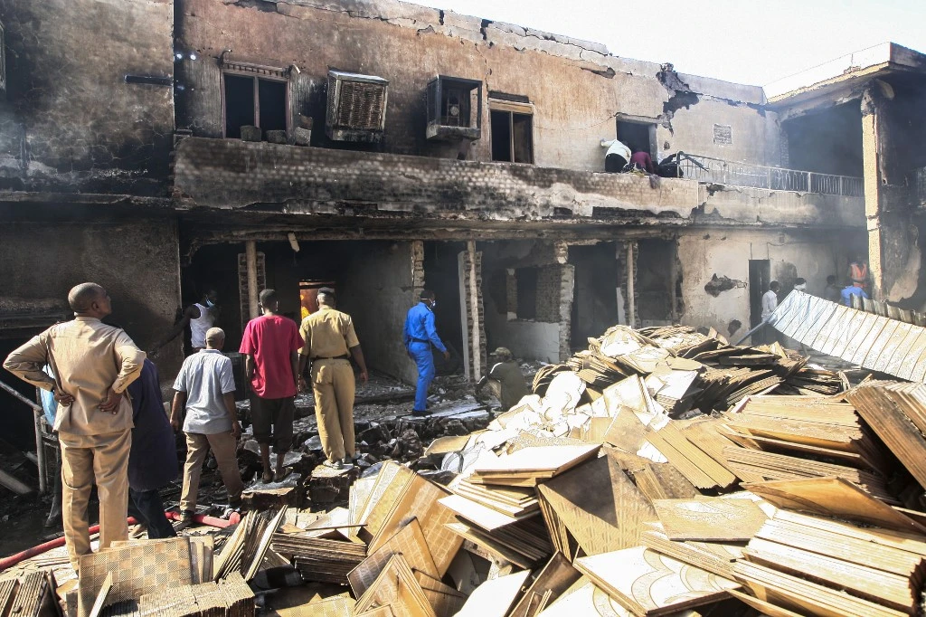 Members of the Sudanese civil defense forces search for victims at the scene of a fire in north Khartoum. (AFP)