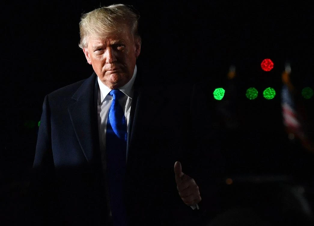 Donald Trump disembarking from Air Force One after landing in the UK for the NATO summit. (AFP)