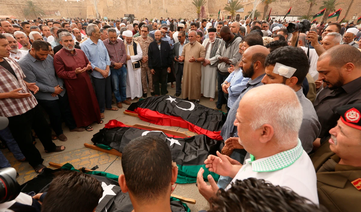 mourners pray for fighters killed in airstrikes by warplanes of Field Marshal Khalifa Hifter's forces, in Tripoli, Libya. (AP)