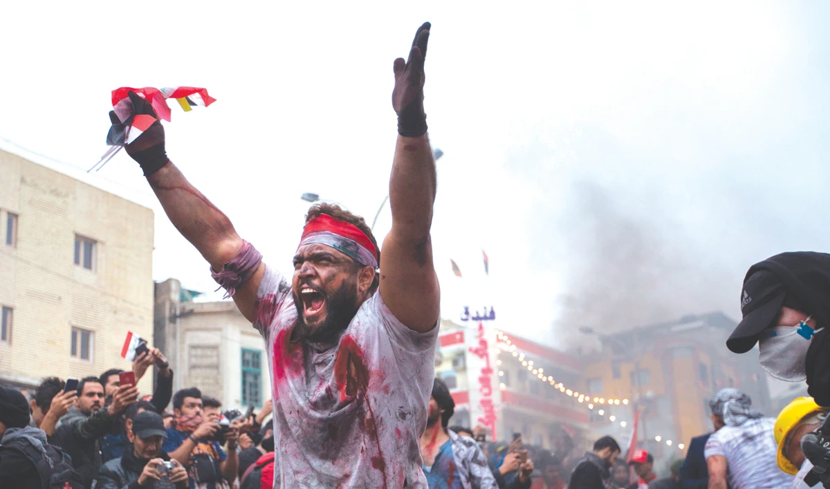 An Iraqi actor gestures as he performs in a play representing the ongoing anti-government demonstrations, in Tahrir Square in Baghdad. (AFP)