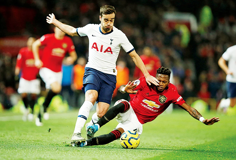 Manchester United’s Fred and Tottenham Hotspur’s Harry Winks during their English Premier Leage match on Wednesday. United beat Tottenham 2-1. (Reuters)