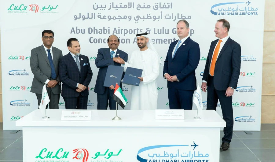 Bryan Thompson signed the agreement with Saifee Rupawala in the presence of Sheikh Mohammad bin Hamad bin Tahnoon Al-Nahyan, Yusuff Ali M.A., and Tony Douglas.