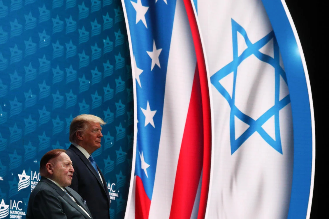 US President Donald Trump stands on stage alongside casino magnate Sheldon Adelson, one of the president’s top financial supporters, at the Israeli American Council National Summit in Hollywood on Saturday, December 7, 2019. (Reuters)