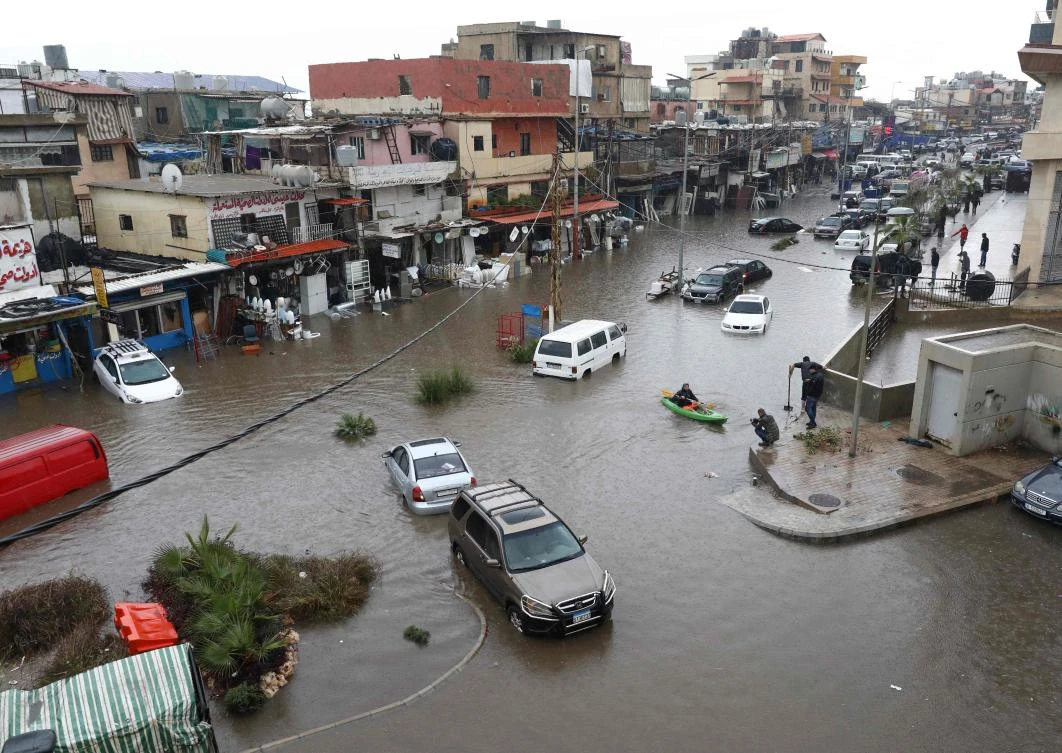 Cars are stuck after breaking down on a flooded road due to heavy rain, at the southern entrance of the Lebanese capital Beirut on December 9, 2019. (AFP)