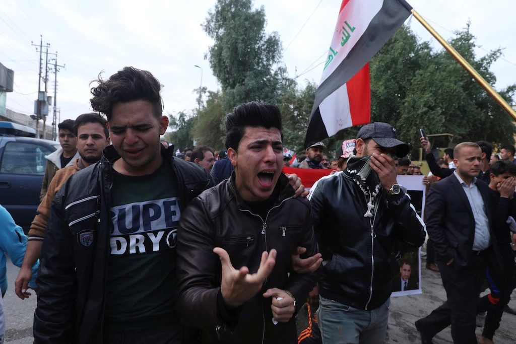 Mourners react during the funeral of the Iraqi civil activist Fahim al-Taie, who was killed overnight, in Kerbala, Iraq December 9, 2019. (Reuters)