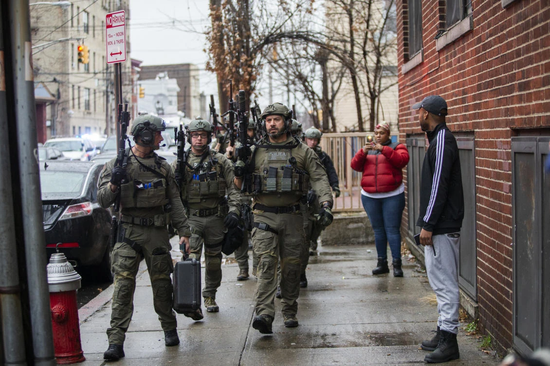 Police officers arrive at the scene following reports of gunfire, in Jersey City, N.J. (AP Photo)
