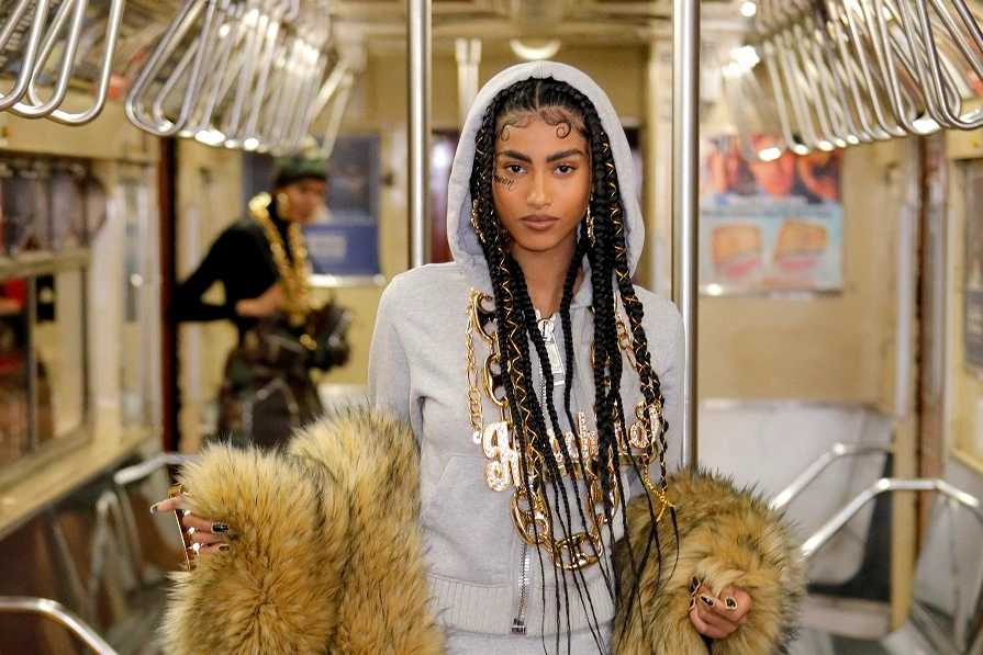 Imaan Hammam rides the NYC subway for Moschino