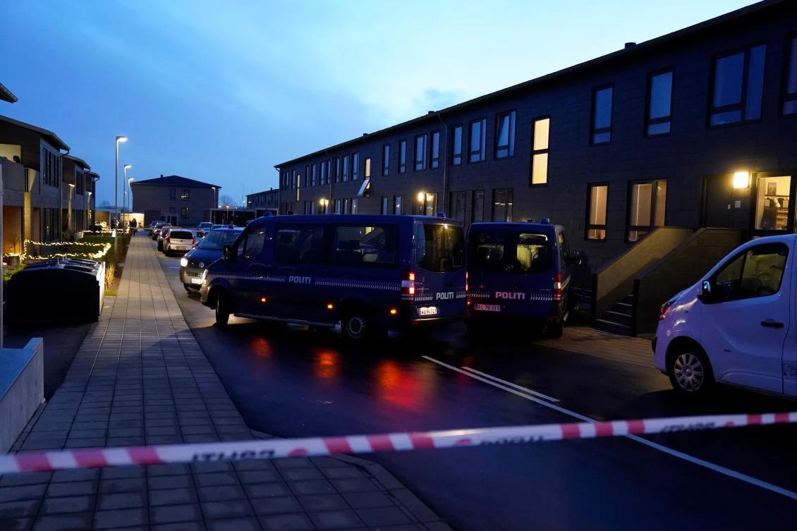 Police cars are parked in front of houses in Aalborg on December 11, 2019. (AFP)