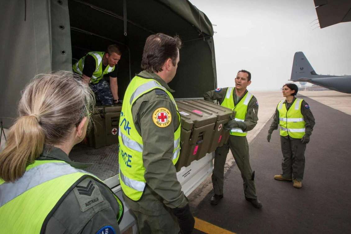 This handout photo taken and released by the Royal Australian Air Force on December 11, 2019 shows No 3 Aeromedical Evacuation Squadron personnel at RAAF Richmond prepare medical equipment to load onto a C-130J Hercules prior to a mission to repatriate Australians who have been injured from the White Island volcanic eruption, at the Royal Airforce Base in Richmond. (AFP)