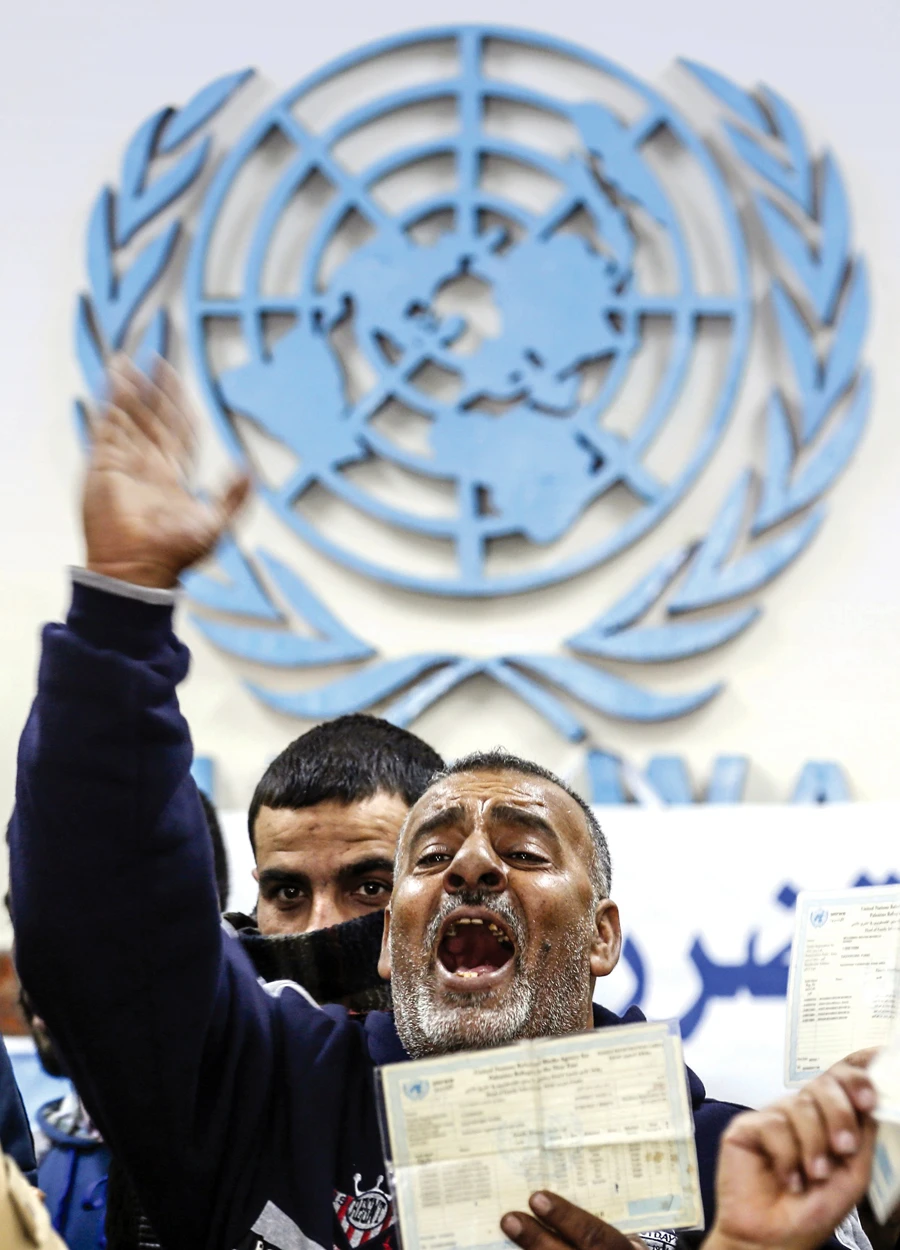 A Palestinian shouts slogans during a protest seeking compensation for the damage to their homes, damaged during the 2014 conflict, in Gaza. (AFP)