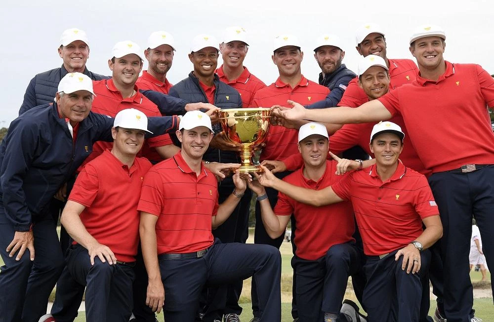 US team player and captain Tiger Woods, center, is now the most successful Presidents Cup golfer in history with a 27-win, 15-loss and 1-tied record. (AP)