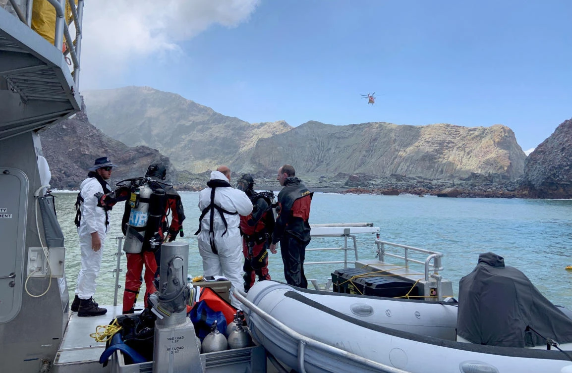 Divers prepare to search the waters near White Island off the coast of Whakatane, New Zealand on Saturday, Dec. 14, 2019. (New Zealand Police via AP)