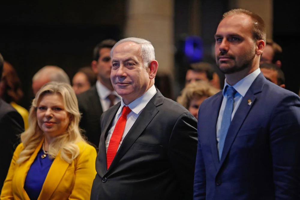 Israeli Prime Minister Benjamin Netanyahu attend with his wife Sara and Brazilian Federal Deputy Eduardo Bolsonaro (R) the opening ceremony of the Brazilian Ministry Trade And Investment Promotion Agency in Jerusalem on Dec. 15, 2019. (AFP)