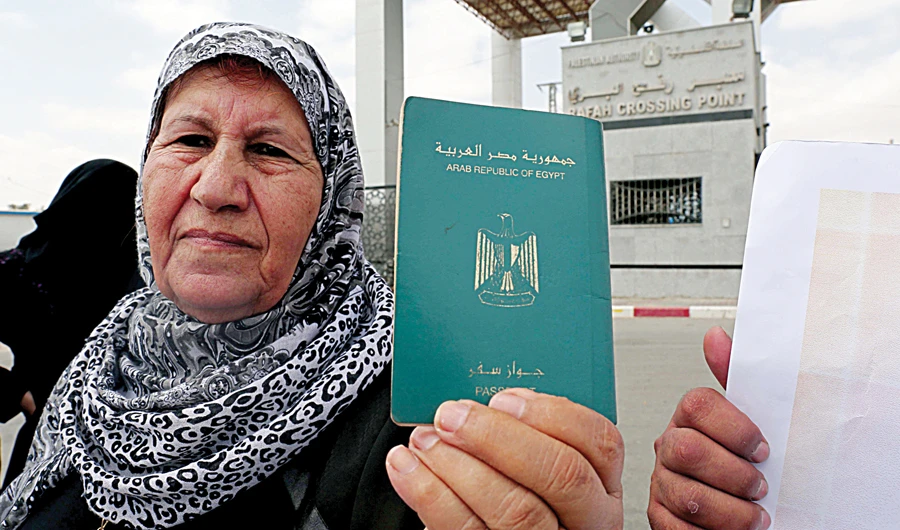 A Palestinian woman holds her Egyptian passport. (AFP)