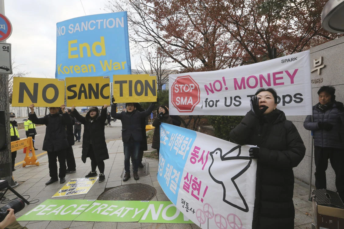 Protesters hold signs to demand peace on the Korean peninsula during a rally in Seoul on Monday, Dec. 16, 2019. (AP)