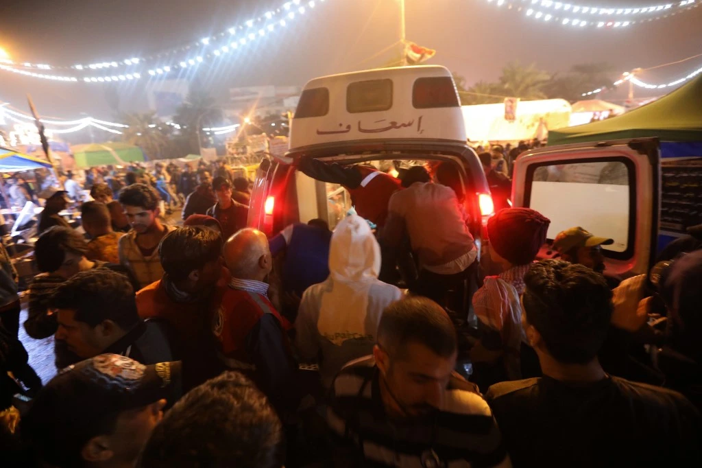 An ambulance arrives in Tahrir square after unidentified men attacked an anti-government protest camp in Baghdad late on Dec. 6. (AFP)