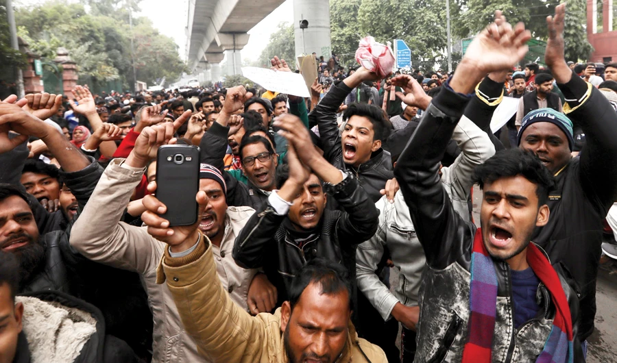 Indian students at the Jamia Millia Islamia University shout slogans during a protest in New Delhi on Monday. (AP)