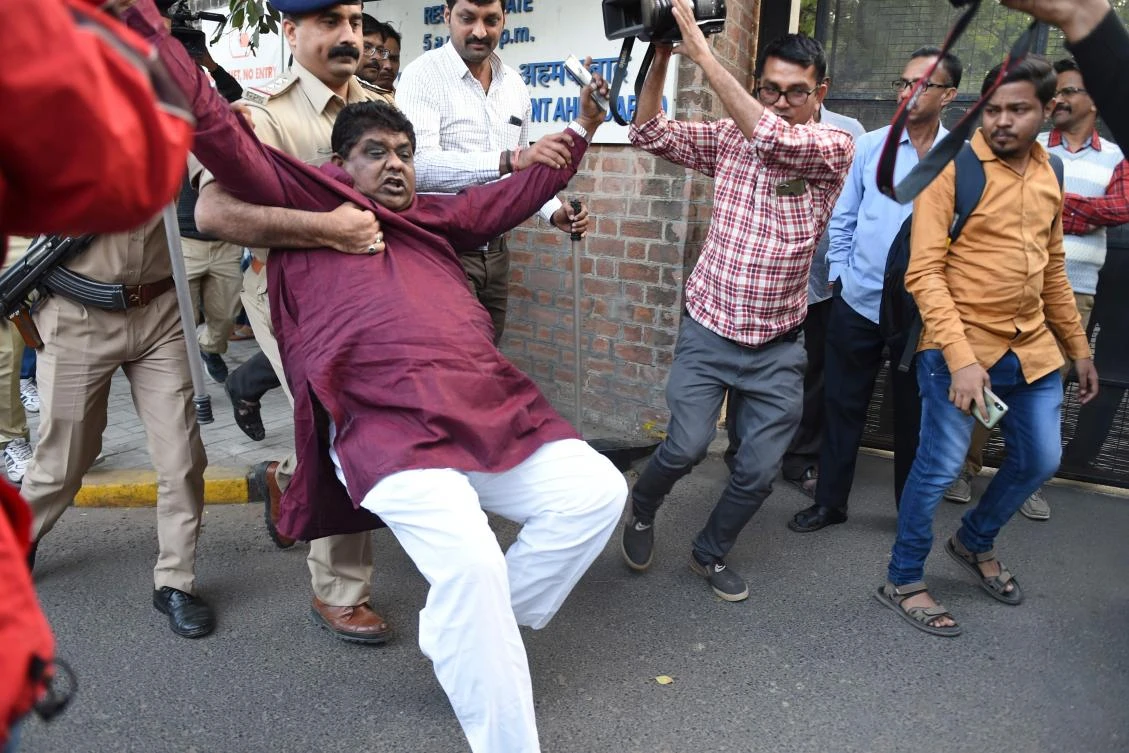 Police personnel detain a demonstrator during a protest against the Indian government’s Citizenship Amendment Act in Ahmedabad on December Monday, 16, 2019. (AFP)