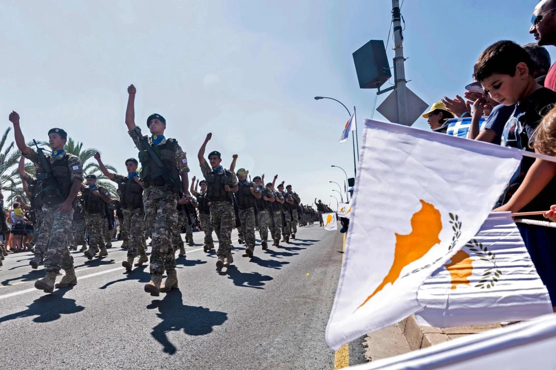 Cypriots wave Greek and Cyprus national flags during a military parade marking the 59th anniversary of Cyprus’ independence from British colonial rule in this October 1, 2019 file photo. (AFP)