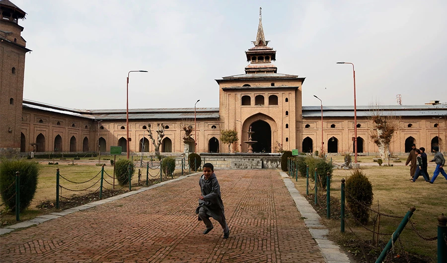 A Kashmiri boy plays outside Jamia Masjid in Srinagar, Indian controlled Kashmir, Wednesday, Dec. 18, 2019. A call to afternoon prayer has rung out from the central mosque in disputed Kashmir’s largest city for the first time in more than four months, ending a virtual ban on religious practice in the Muslim-majority region's biggest mosque. (AP)