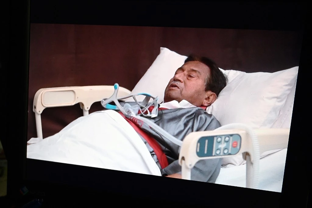 A video statement of the ailing exiled former Pakistani military ruler Pervez Musharraf in a hospital bed in Dubai is pictured on a screen in Islamabad on December 19, 2019. (File/AFP)