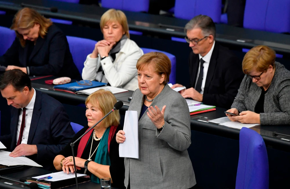 German Chancellor Angela Merkel (C) addresses MPs during a question time at the Bundestag (lower house of parliament) on Dec. 18, 2019 in Berlin. (AFP)