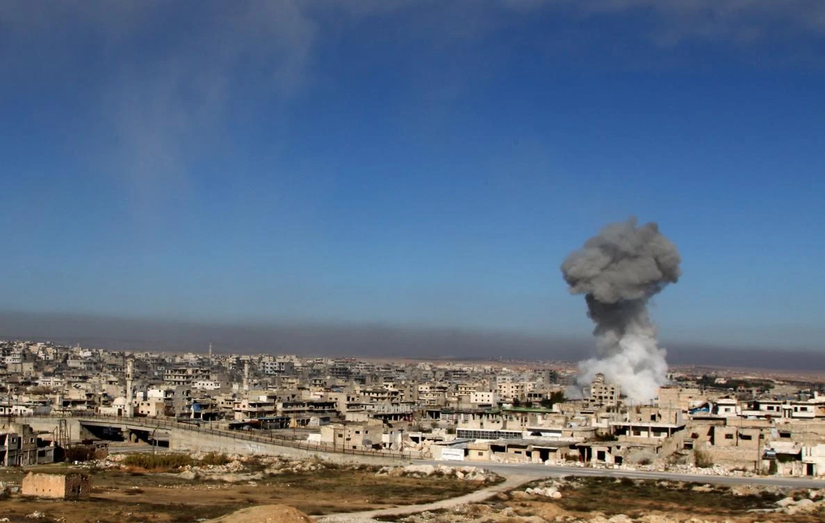 A smoke plume billows following a reported Syrian government air strike on a residential district of Maaret al-Numan in the northwestern Idlib province on December 18, 2019. (AFP)