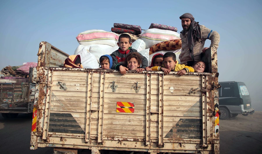 Syrians carrying their belongings drive towards the northern areas of Syria's Idlib province near the Syrian-Turkish border as they flee the bombardments in the southern areas of the country's last major opposition bastion, on December 20, 2019. (AFP)