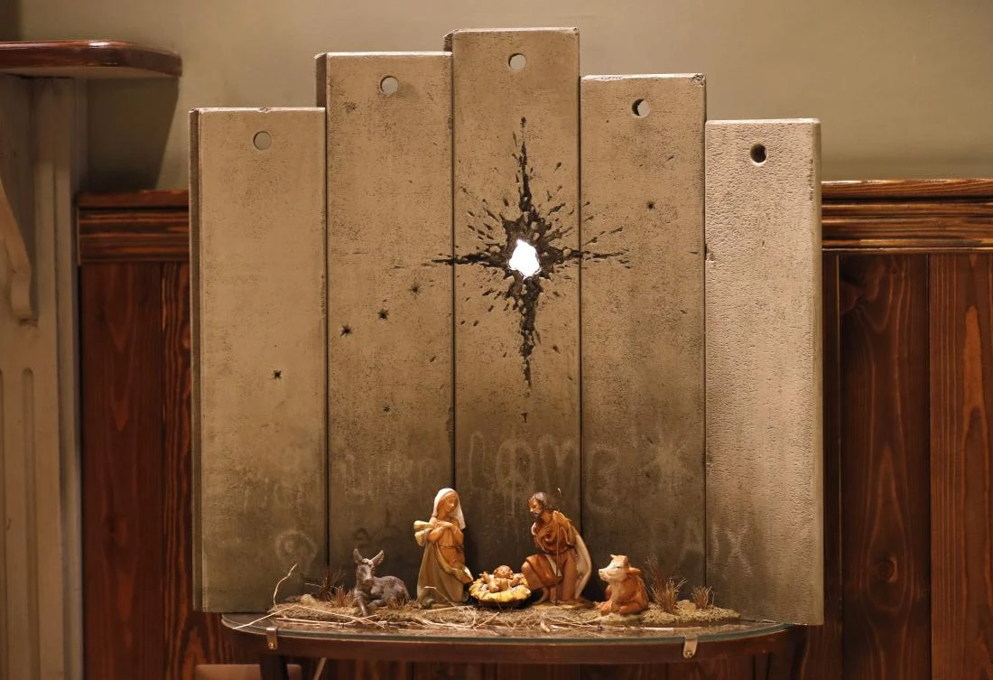 The ‘Scar of Bethlehem’ is installed at Banksy’s Walled-Off Hotel, where all rooms overlook a concrete section of the barrier built by Israel to cut off the occupied West Bank from Israeli territory. (AFP)