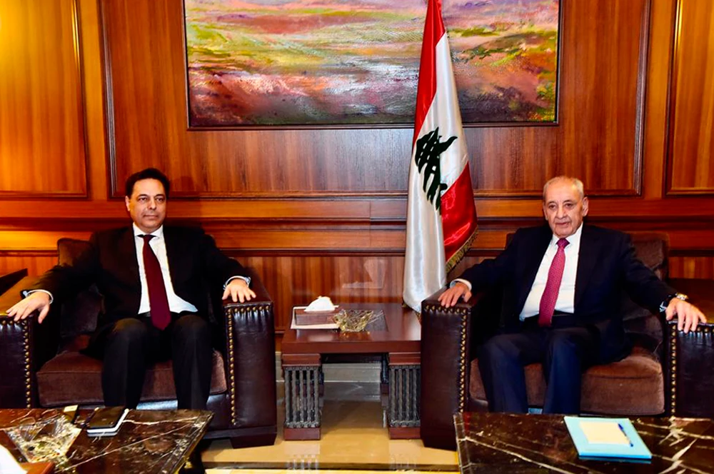 Newly-assigned Lebanese Prime Minister Hassan Diab, right, meets with Parliament Speaker Nabih Berri in Beirut, Lebanon, on Dec. 21, 2019 as he began consultations on forming a government of experts and independents to deal with the country's crippling economic crisis. (Dalati Nohra via AP)