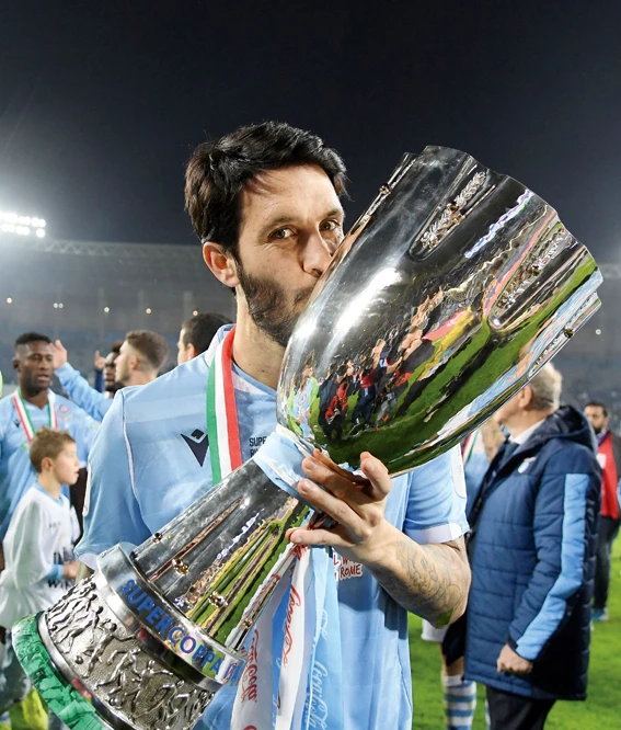Lazio's Luis Alberto celebrates winning the Italian Super Cup with the trophy. (Reuters)
