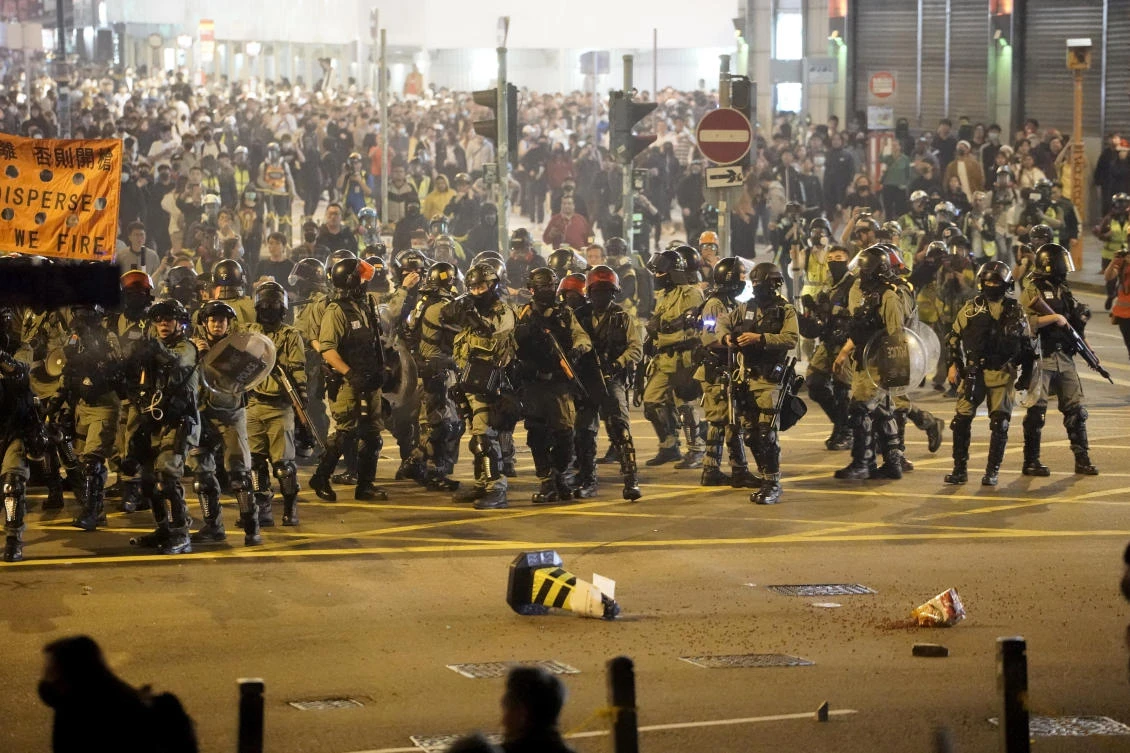 Riot police gather as they confront protesters during a rally on Christmas Eve in Hong Kong on Tuesday, Dec. 24, 2019. (AP)