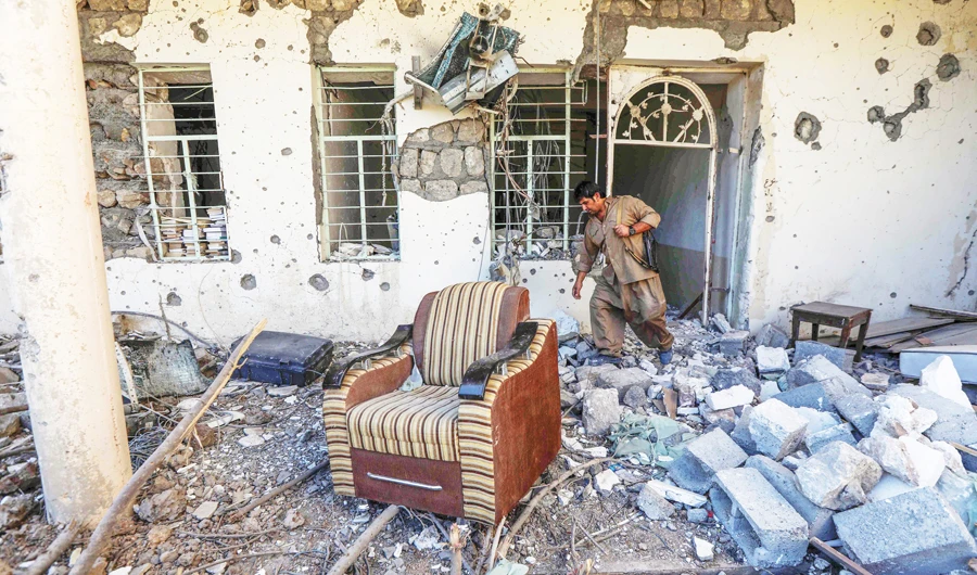 A member of Iran’s Kurdish Democratic Party inspects damage to the group’s headquarters in Koysinjaq after it was hit by an Iranian rocket. Tehran has focused its deadliest repression on Kurdish areas of the country. (AFP)