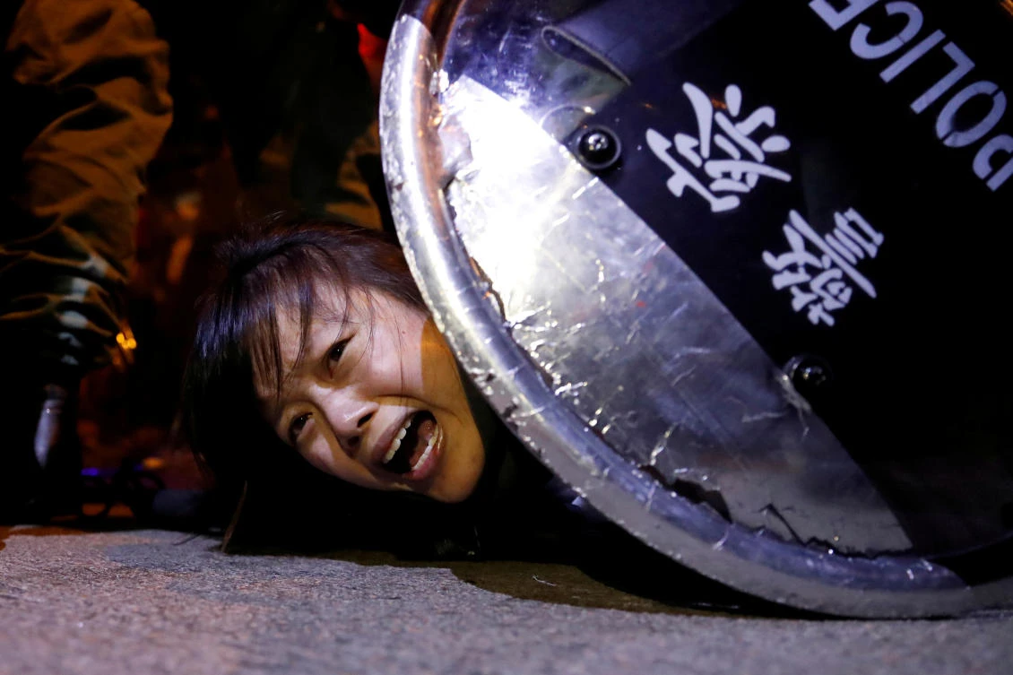 An anti-extradition bill protester is detained by riot police during a protest outside Mong Kok police station in Hong Kong. (File/Reuters)