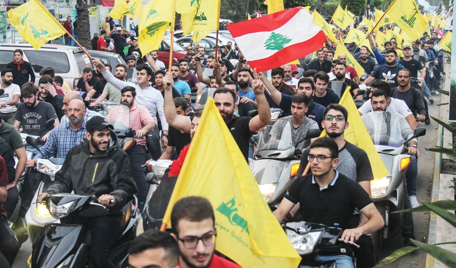 Divide and rule: Hezbollah supporters rally in southern Beirut to show their support for the group’s combative leader, Hassan Nasrallah. (AFP)