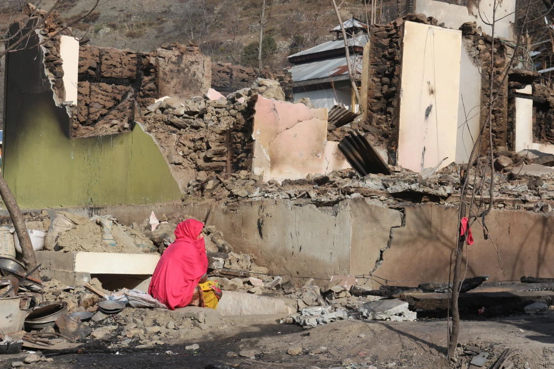A Pakistani Kashmiri woman sits amid the debris of her home that was reportedly destroyed by cross border shelling from Indian troop on Monday, Dec. 23, 2019. (AP)