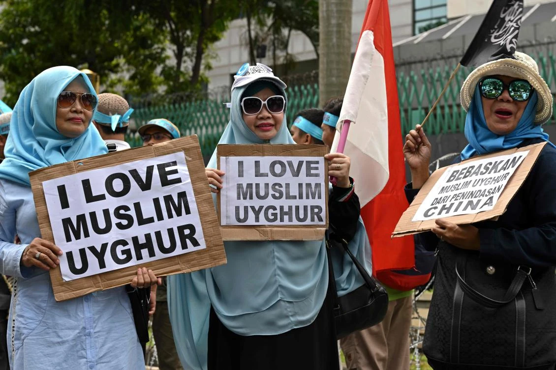 Indonesian hardline Muslim group members take part in an anti-China rally in front of Chinese embassy in Jakarta, on December 27, 2019, to condemn China's government for rounding up an estimated one million Uighurs and other mostly Muslim ethnic minorities in internment camps in the northwestern region of Xinjiang. (AFP)