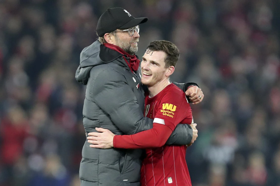 Liverpool's manager Jurgen Klopp embraces Liverpool's Andrew Robertson at the end of the English Premier League soccer match between Liverpool and Wolverhampton Wanderers at Anfield. (AP)