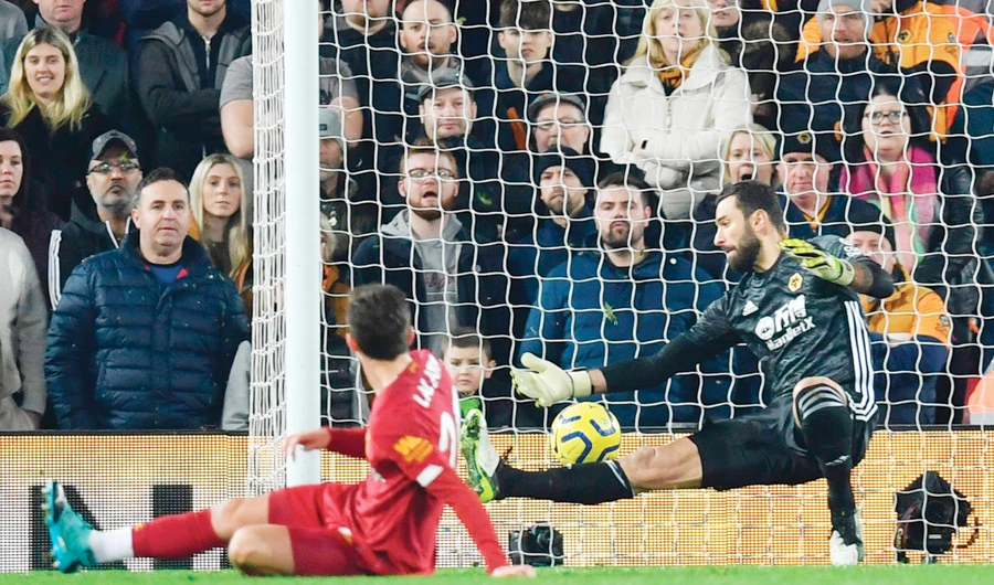 The ball beats Wolverhampton Wanderers’ Portuguese goalkeeper Rui Patricio, right, for Liverpool’s first goal scored by Senegalese striker Sadio Mane. (AFP)