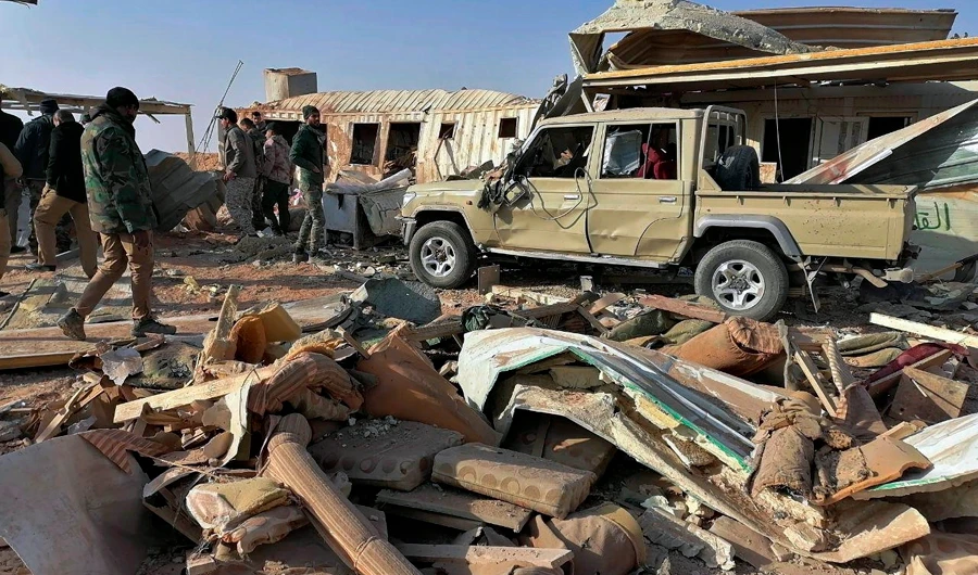 Onlookers inspect the destruction of militia site after the airstrike in Iraq. (AP)