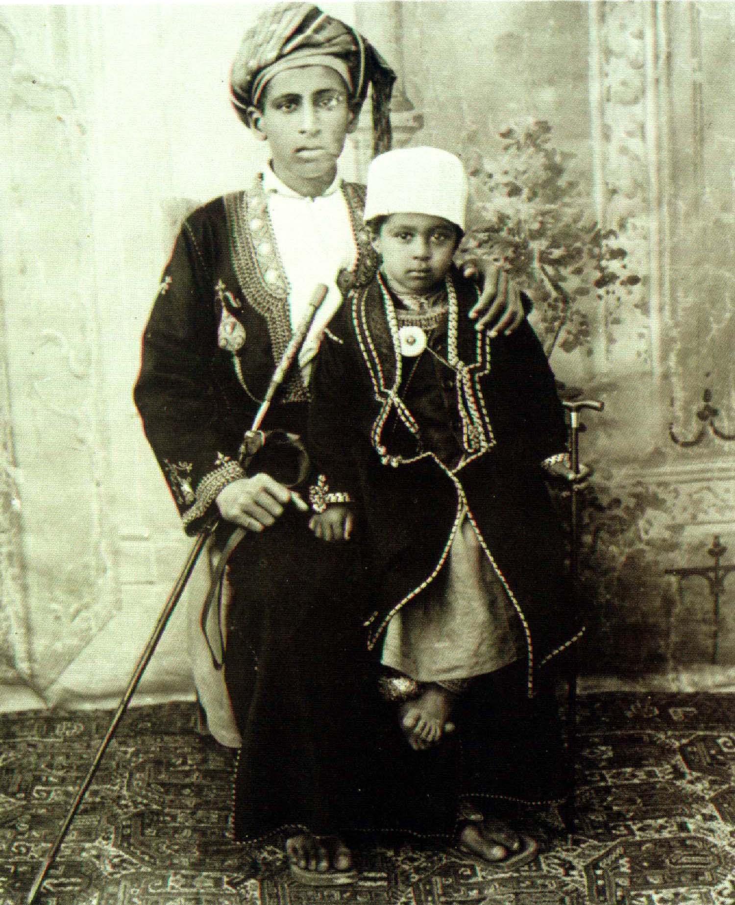 Sultan Qaboos as a child sitting on his father's lap in Oman. (AFP / Omani Royal Palace)