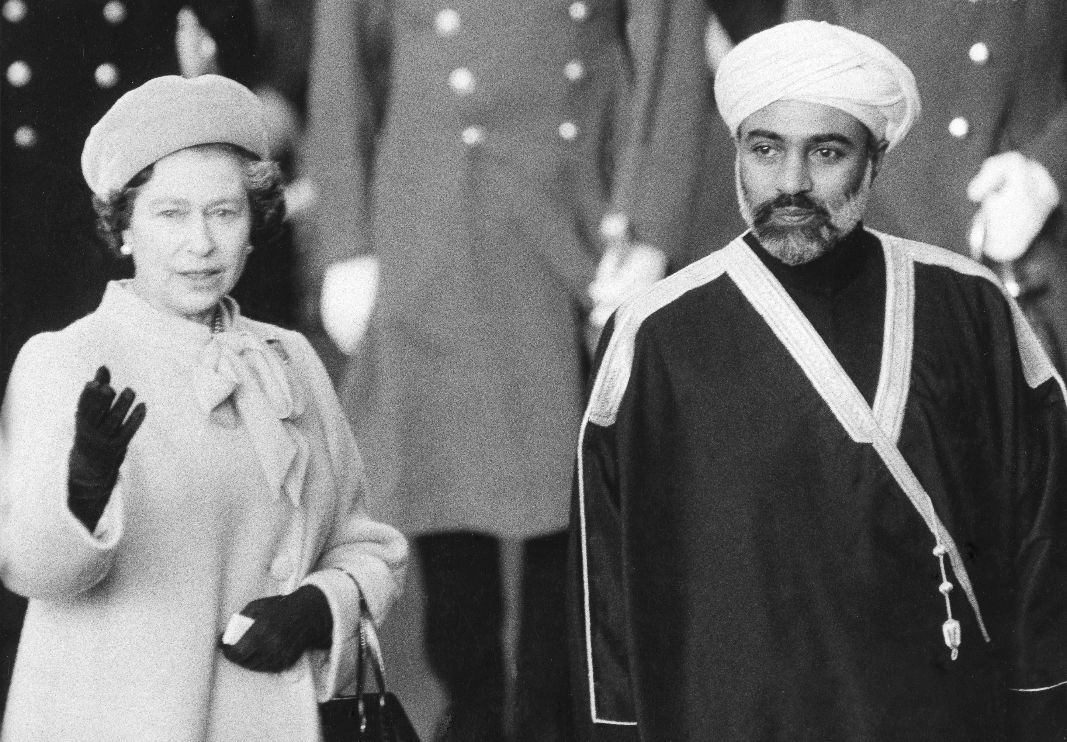 Britain's Queen Elizabeth II gives a wave to the crowd as she greeted Sultan Qaboos at London's Victoria station during a state visit in 1982. (AP/File)