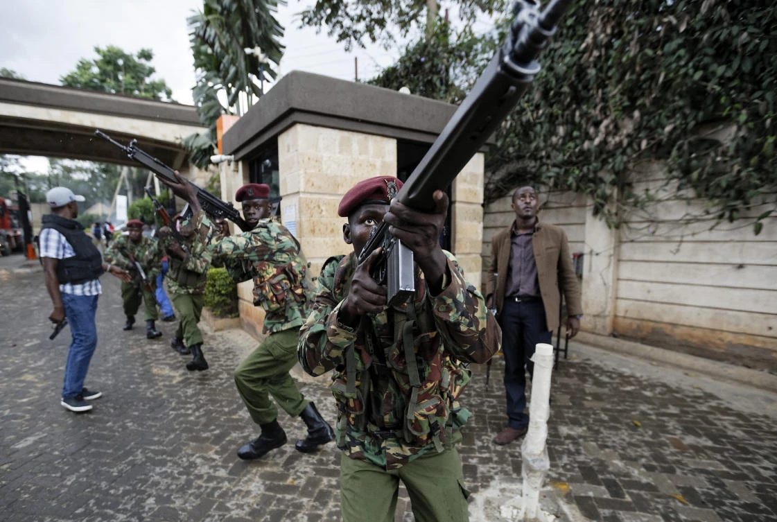 In this Tuesday, Jan. 15, 2019 file photo, Kenyan security forces aim their weapons up at buildings as they run through a hotel complex during an attack by extremists in Nairobi, Kenya. (AP)