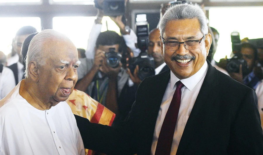 Sri Lankan President Gotabaya Rajapaksa with Tamil National Alliance party leader R. Sampanthan at Parliament on Friday. (AFP)