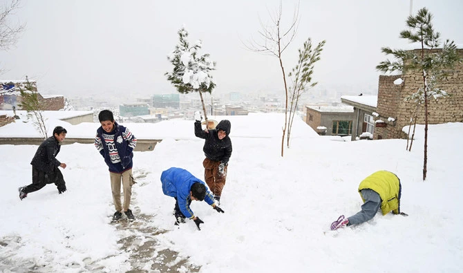 Children play with snow in their neighbourhood in Kabul on January 2, 2020. (AFP)